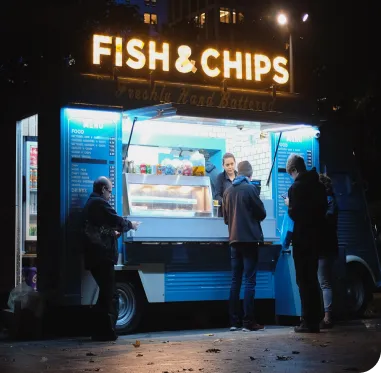 Fish and Chips neon sign above a food truck