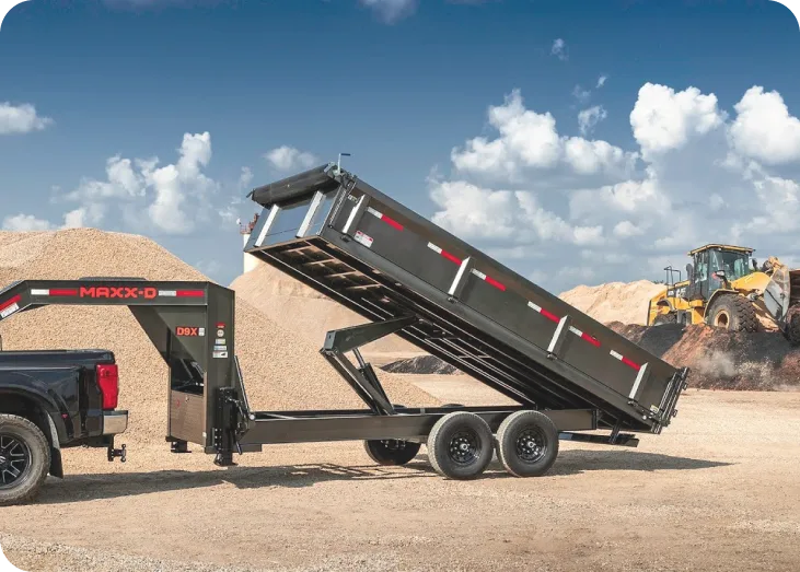 a dump truck with a load of dirt behind it