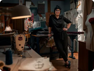 a woman standing next to a sewing machine