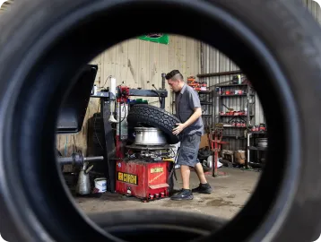 A man fitting a new tire on a rim