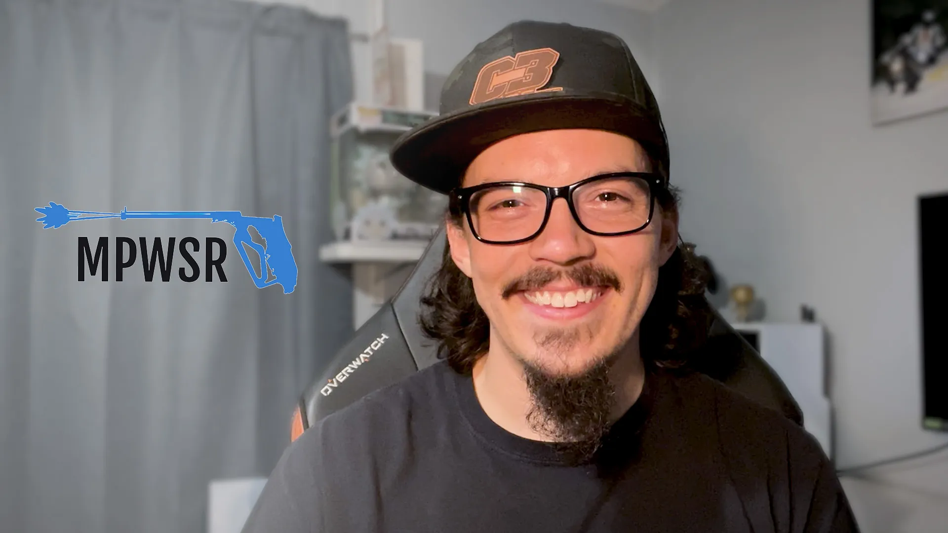 a man with a beard wearing a hat and glasses