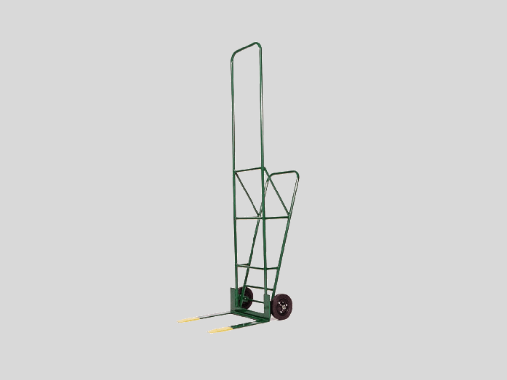 Green metal hand truck with two wheels and yellow-tipped forks against a plain gray background.