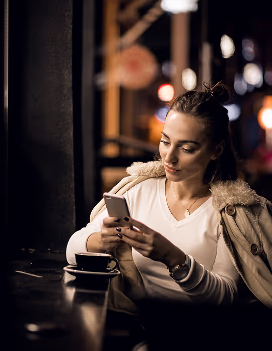 A man wearing a white safety helmet and a yellow high-visibility jacket with reflective stripes.