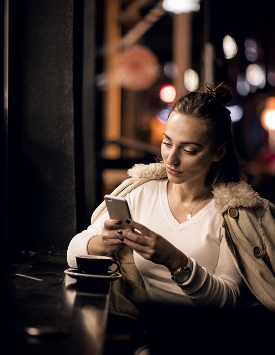 A man wearing a white safety helmet and a yellow high-visibility jacket with reflective stripes.