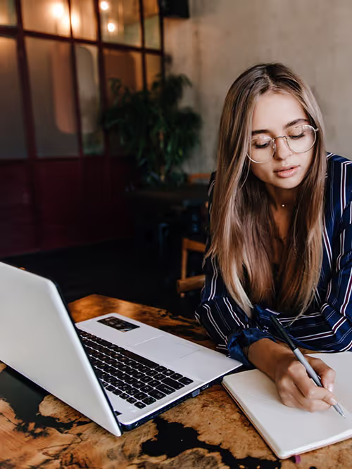 Professional translator reviewing documents at a desk, representing certified translation services for legal and business documents