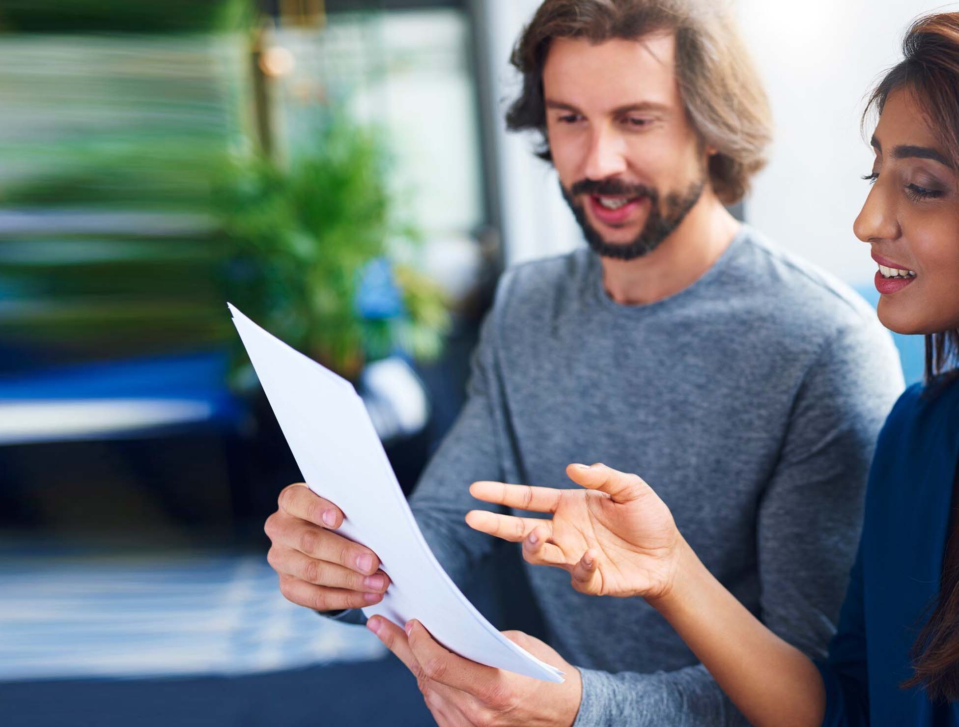 Two diverse professionals engaged in multilingual communication, symbolizing global connection through language services