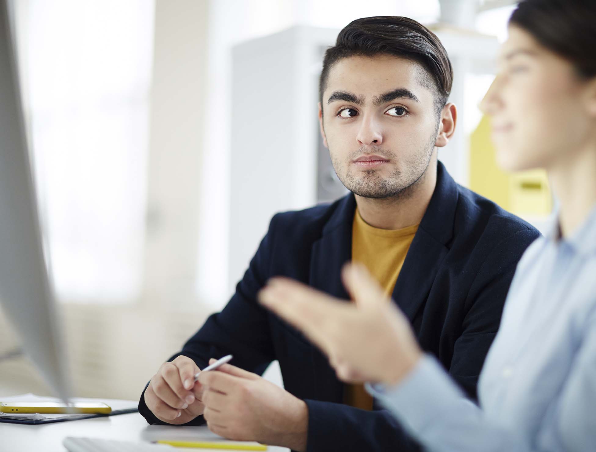A professional on-site interpreter facilitating real-time multilingual communication during an in-person discussion, ensuring accuracy, clarity, and cultural sensitivity.