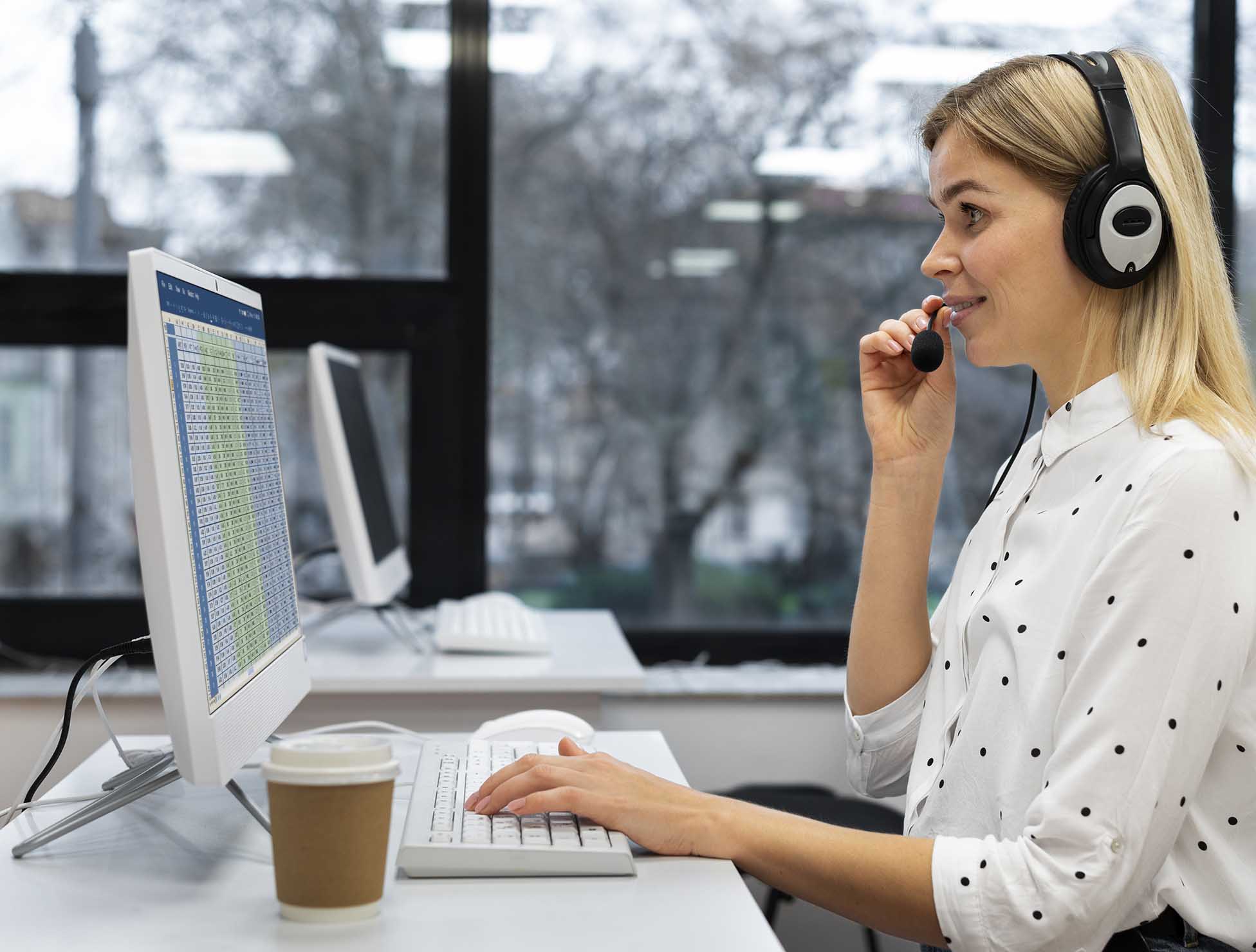 A professional interpreter wearing a headset, providing over-the-phone interpretation services in a modern office setting.