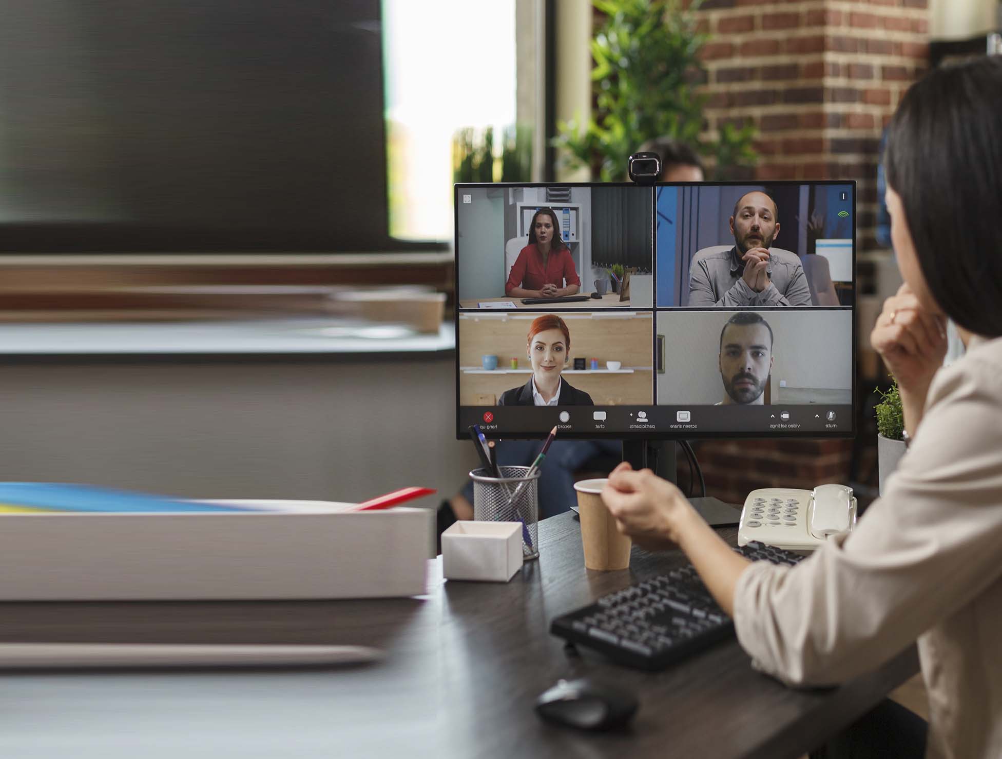 A professional interpreter conducting a video remote interpretation (VRI) session, facilitating multilingual communication through a virtual meeting.