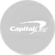Capital One logo with a white swoosh on a black circular background.