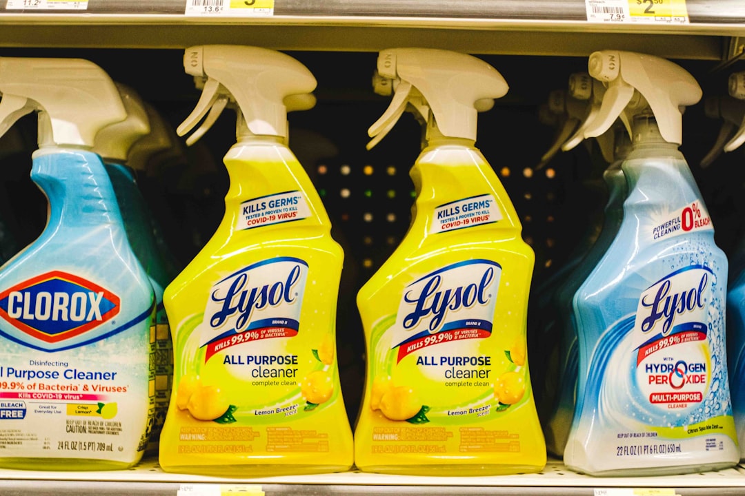 common household cleaning supplies and chemicals in a kitchen cabinet - how to improve indoor air quality at home