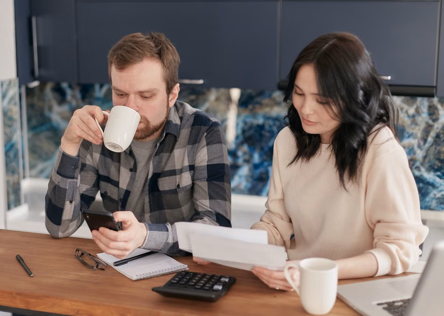 a homeowner reviewing lower utility bills on a tablet