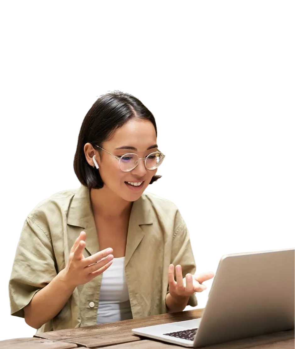 A woman sitting at a table using a laptop computer.