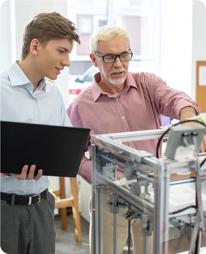 A man and a boy looking at a computer screen.