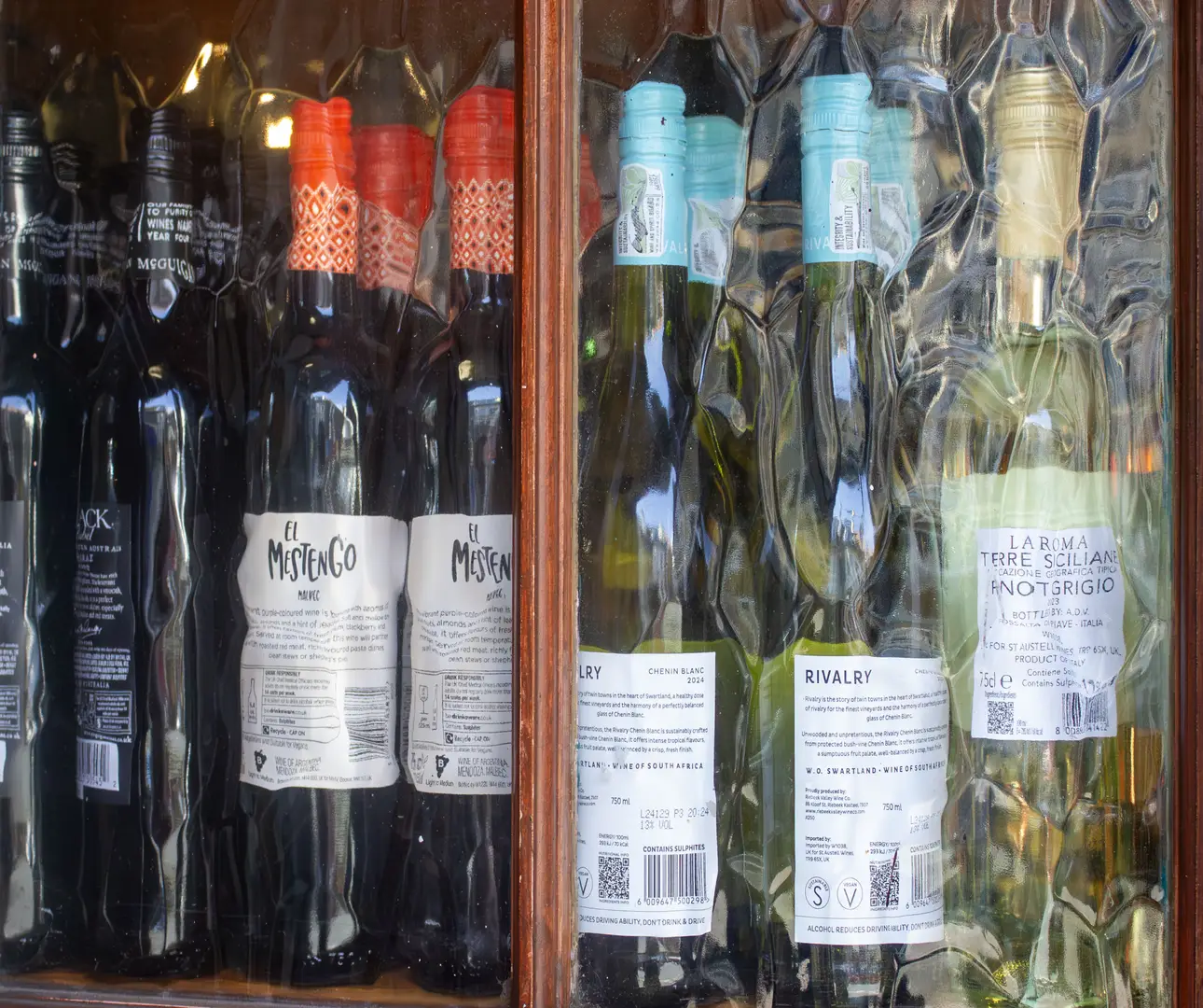 display image of wine bottles in the window of a local pub The Kingsdown Vaults in the central area of Kingsdown, Bristol.