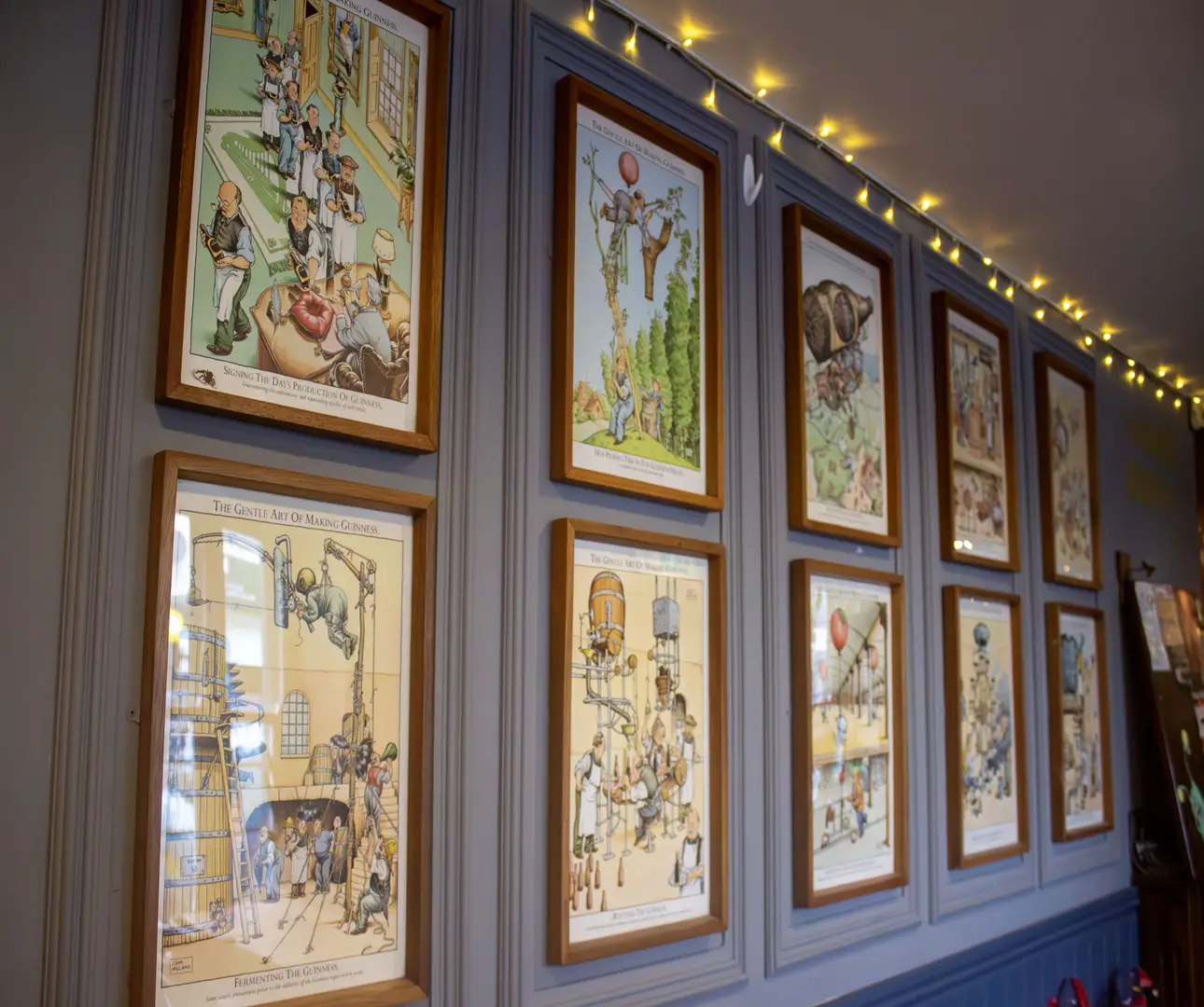 Vintage illustrations hanging on a pub wall in Redfield, Bristol