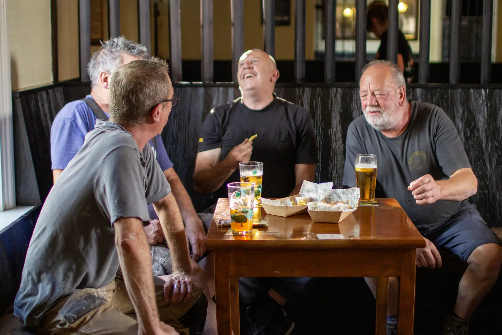 Friends enjoy laughs, drinks, and hearty pub food at The Annexe, a vibrant sports pub in Bishopston.
