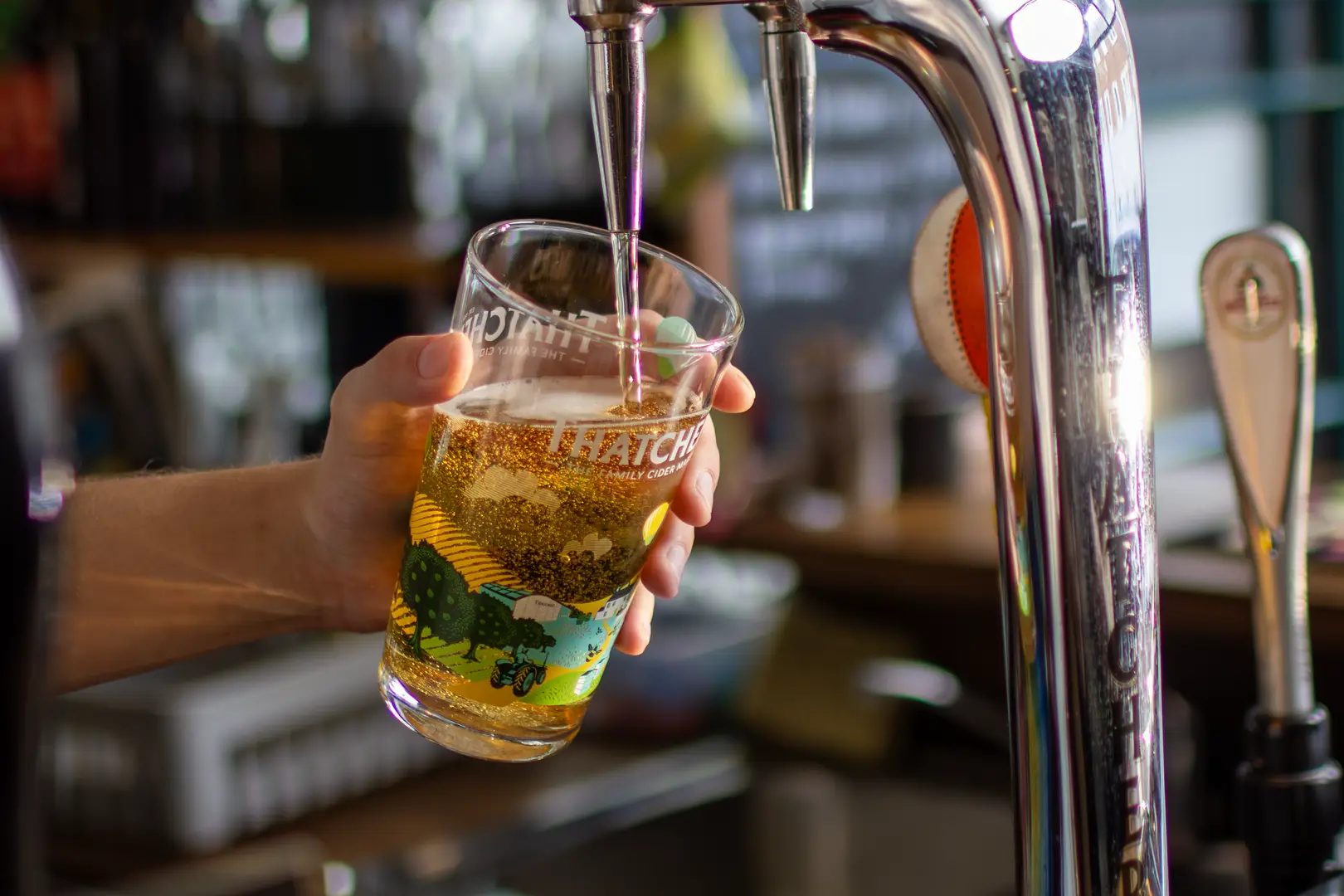 Beautifully golden Thatchers Cider being poured in a local pub in Kingsdown, Bristol