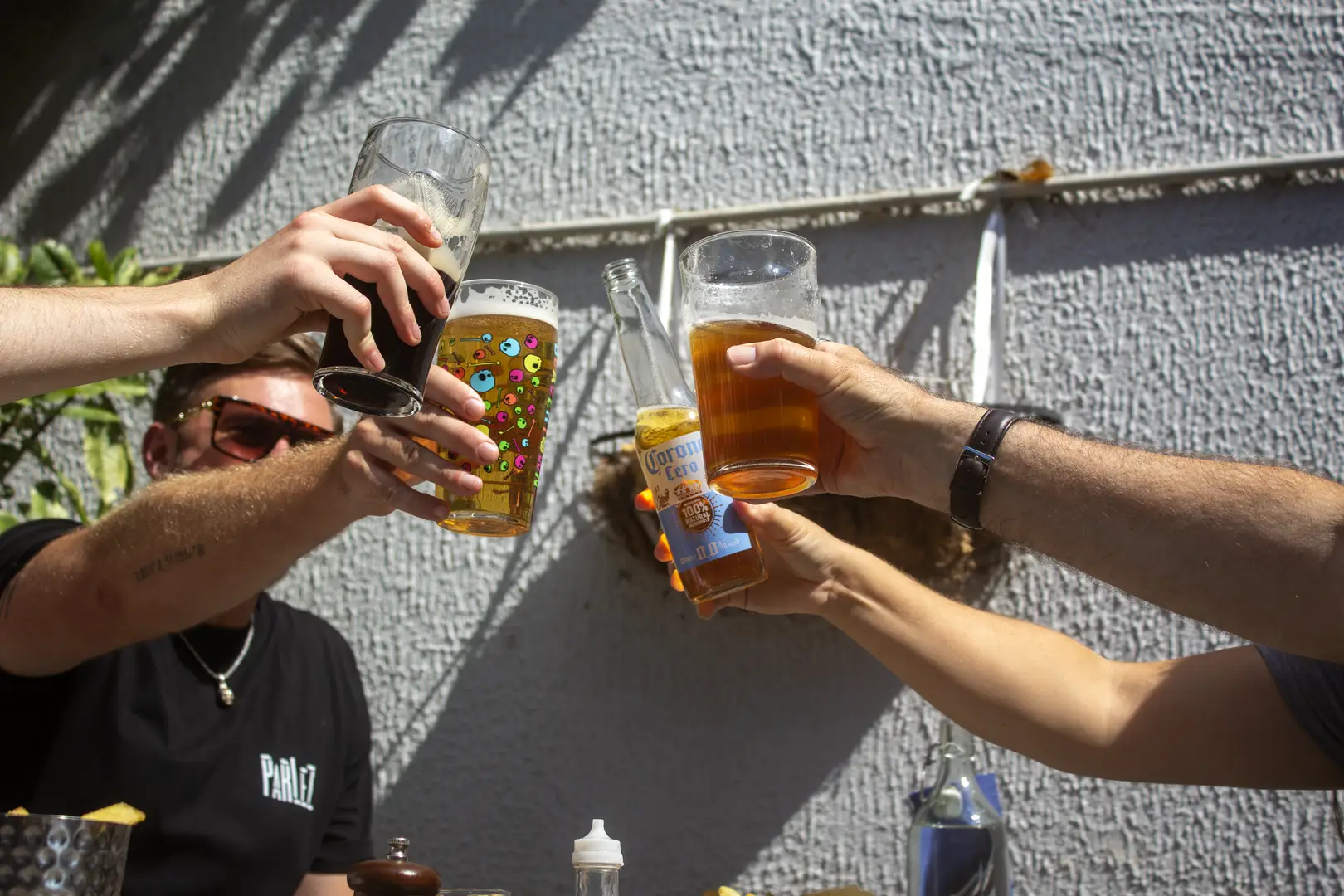 friends cheering a selection of classic pub drinks in a sunny outside pub garden in the Star and Dove, Totterdown, Bristol 