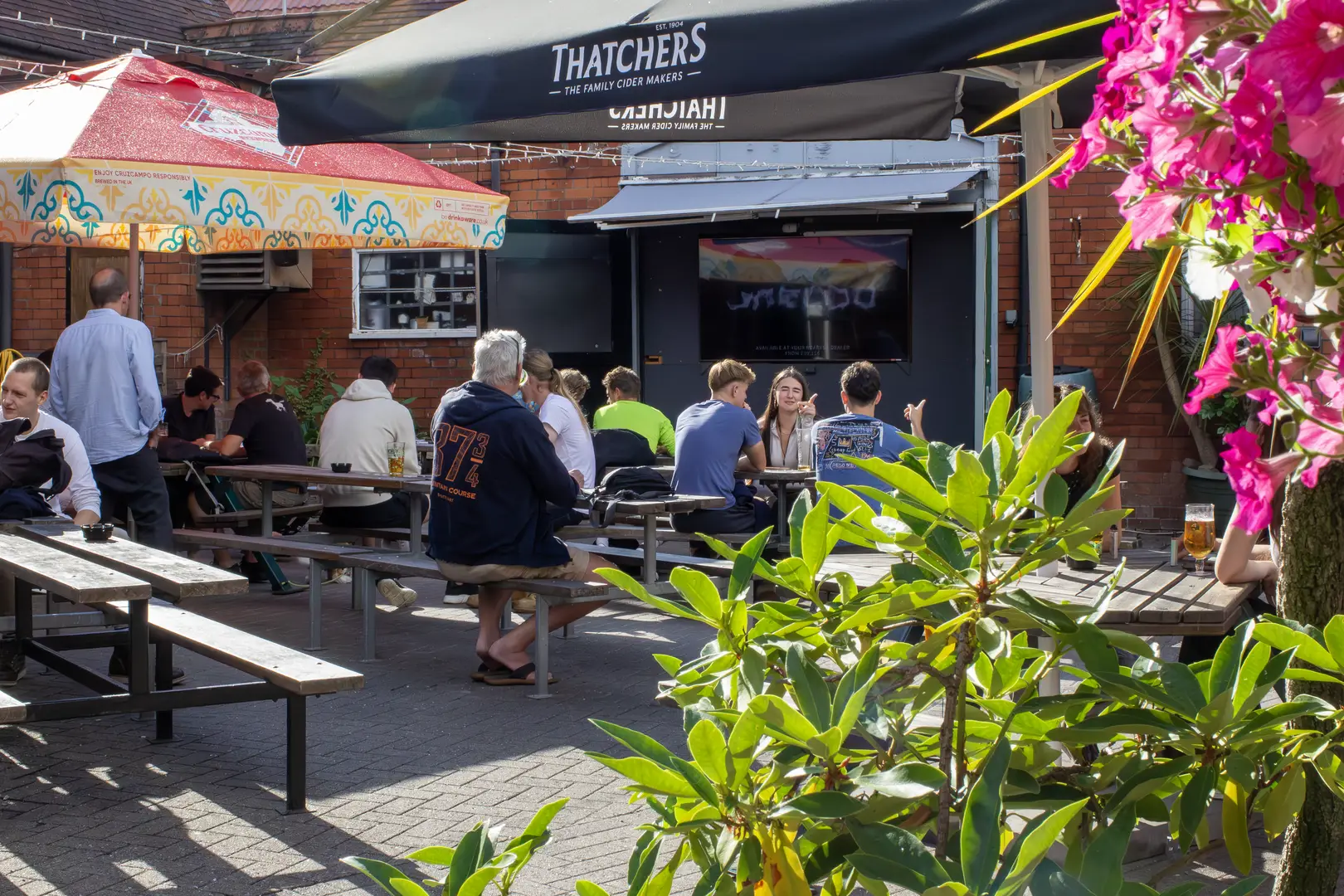 Sunny and spacious beer garden courtyard for The Sportsman, Bishopston, Bristol. A popular sports pub with outdoor seating and screens. 