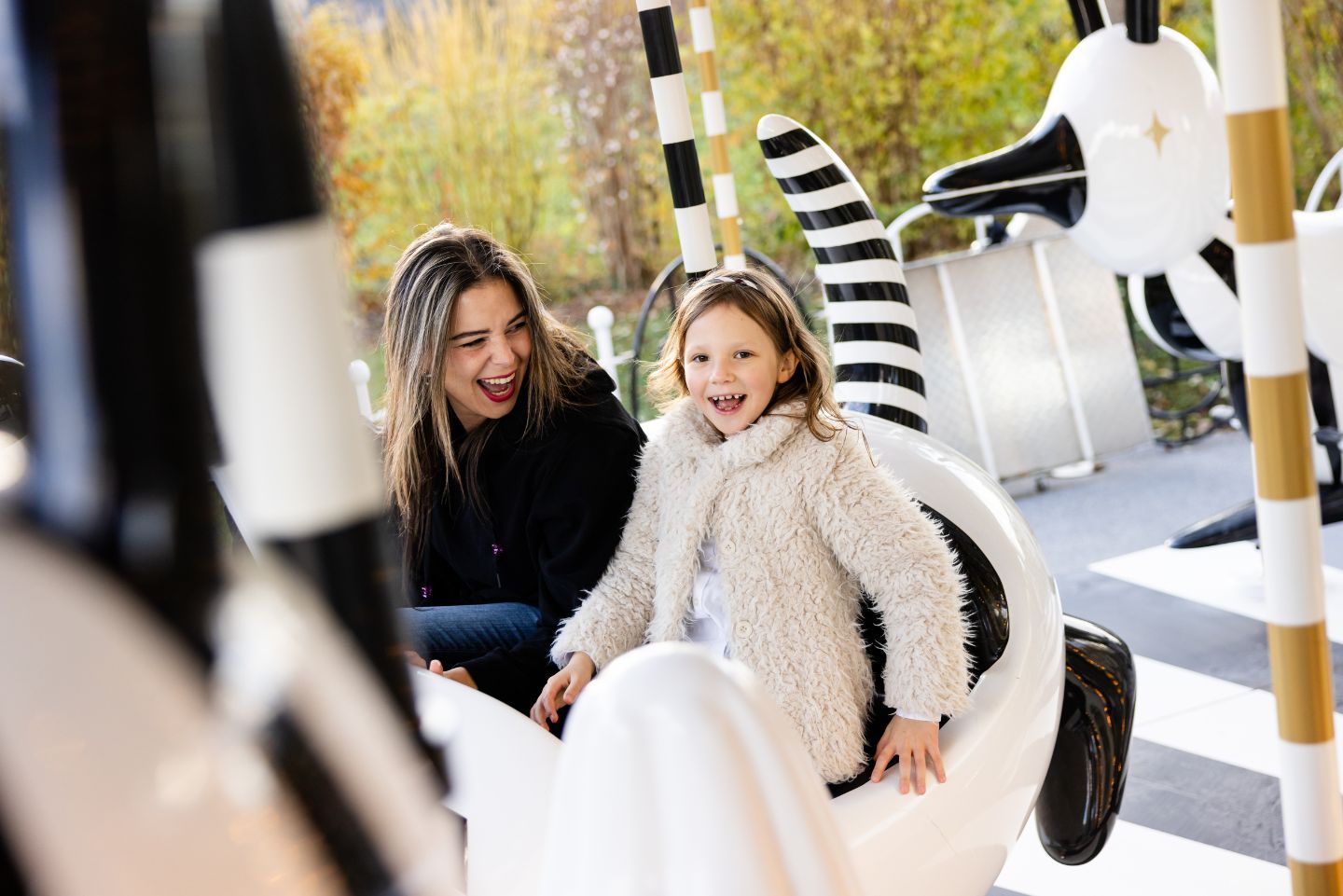 Mother and daughter enjoy a ride on the carousel in the park of Swarovski Kristallwelten — one of many unforgettable experiences with the annual pass.