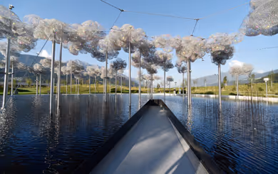 Crystal cloud with sparkling crystals over mirror water in the park of Swarovski Kristallwelten in Wattens, Tyrol.