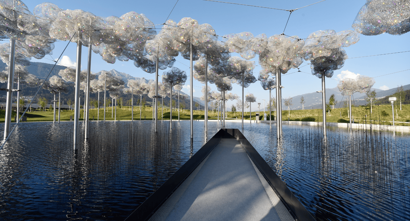 Crystal cloud with sparkling crystals over mirror water in the park of Swarovski Kristallwelten in Wattens, Tyrol.
