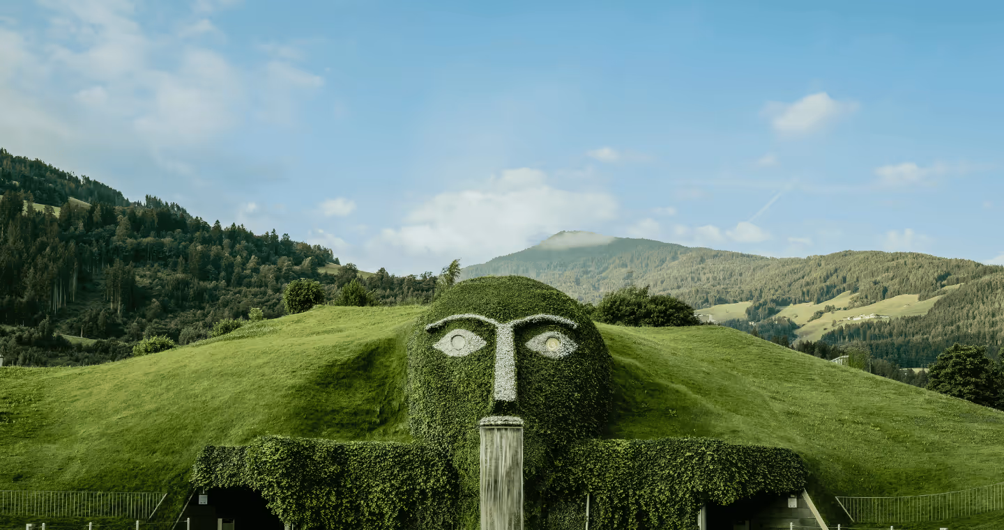 The distinctive giant with glowing eyes and waterfall at Swarovski Kristallwelten Wattens, surrounded by the Tyrolean mountain backdrop.
