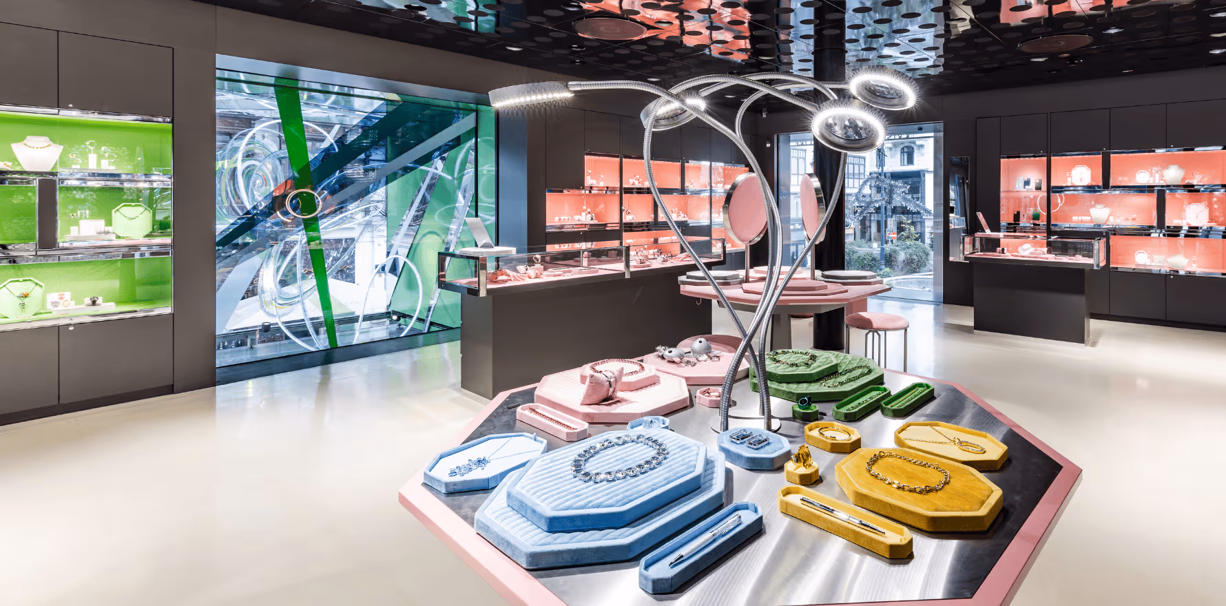 Interior view of the Swarovski Kristallwelten Store Wien with colorful showcases and modern jewelry presentations in pastel color displays.