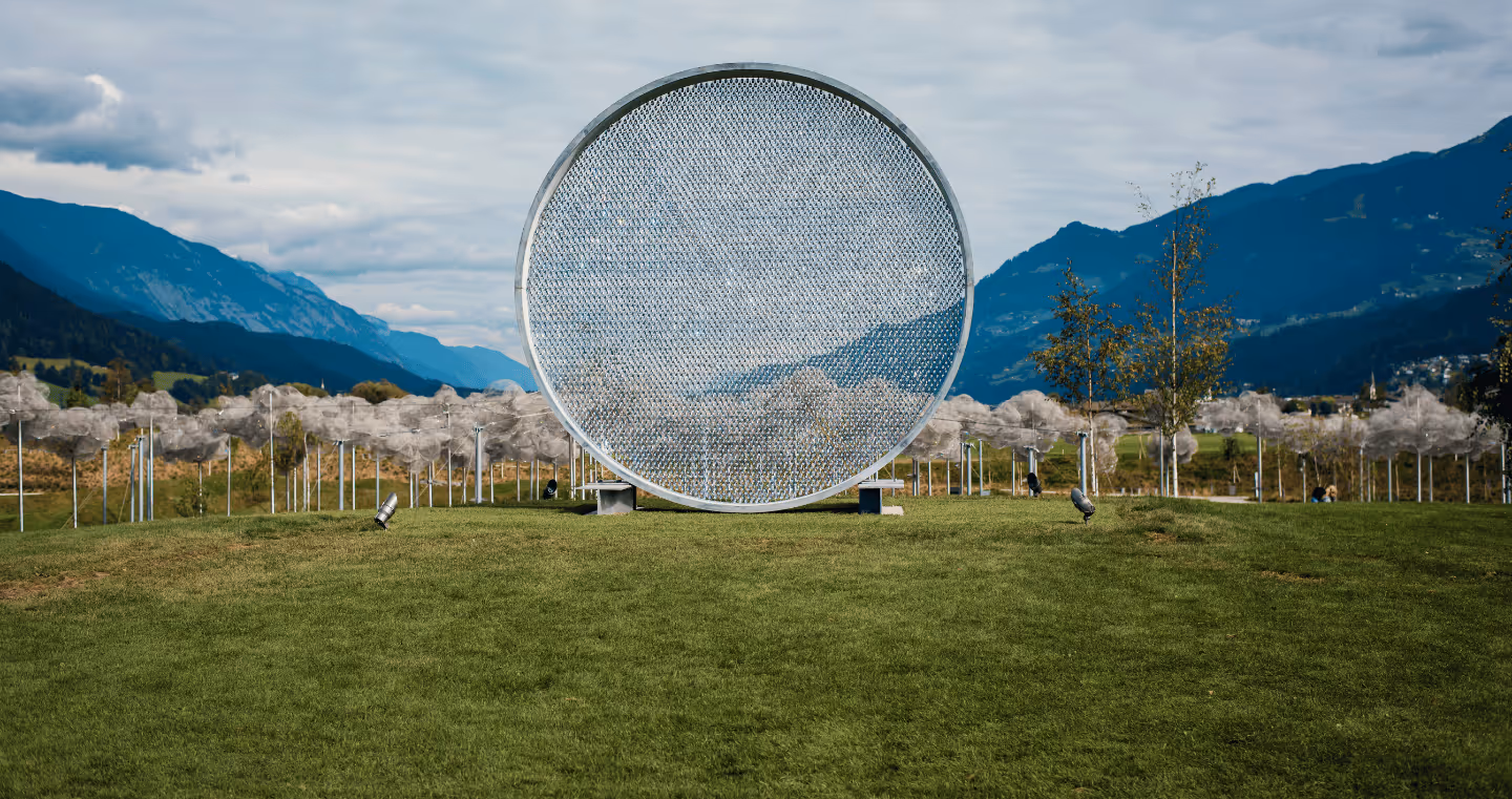 Prologue III art installation in the park of Swarovski Kristallwelten — a circular work of thousands of sparkling crystals, nestled in the Tyrolean mountain landscape.