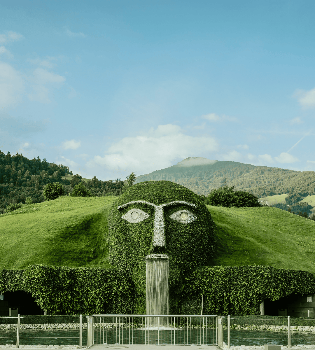 The distinctive giant with glowing eyes and waterfall at Swarovski Kristallwelten Wattens, surrounded by the Tyrolean mountain backdrop.