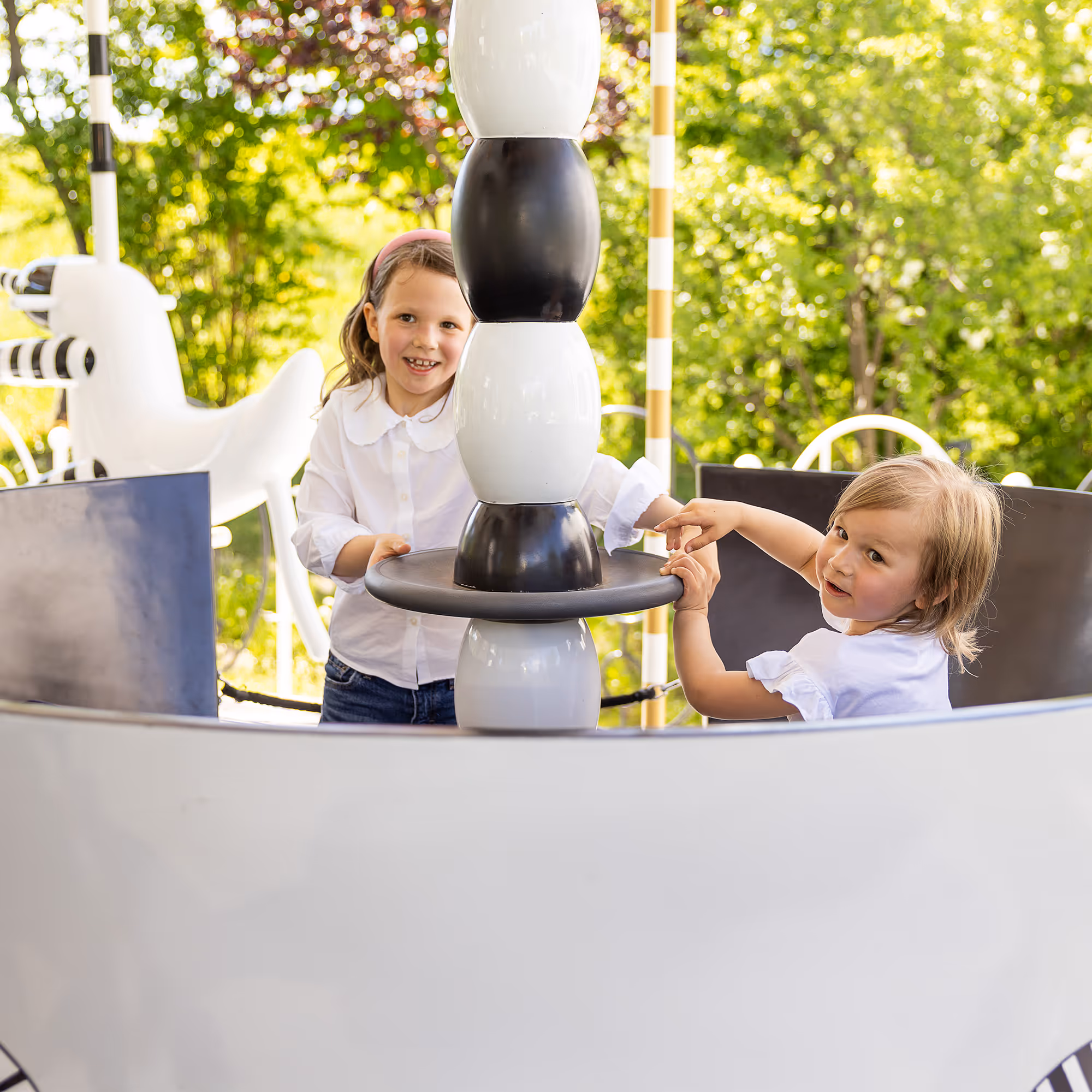 Two children play in the sparkling carousel at Swarovski Kristallwelten — fun for the whole family.