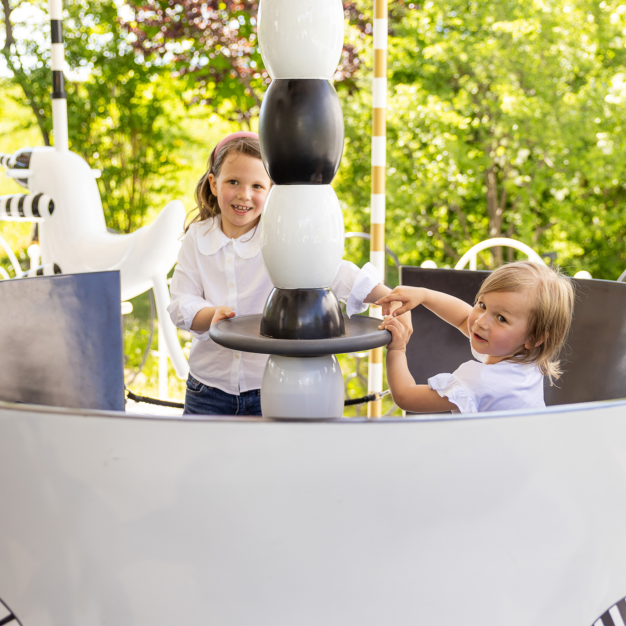 Two children play in the sparkling carousel at Swarovski Kristallwelten — fun for the whole family.