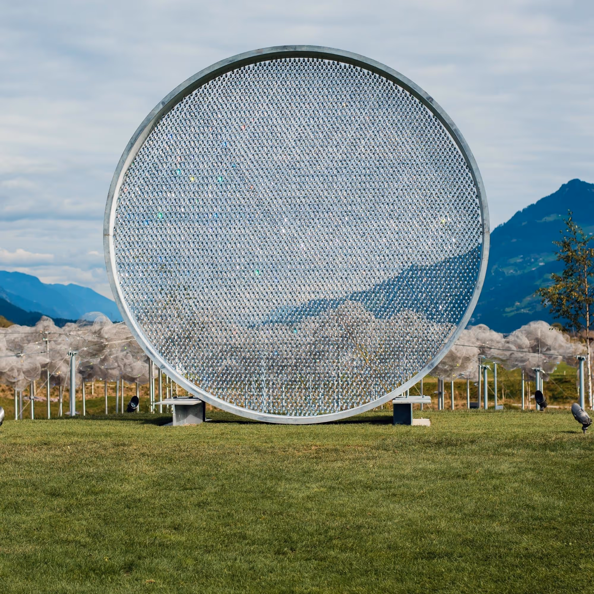 Prologue III art installation in the park of Swarovski Kristallwelten — a circular work of thousands of sparkling crystals, nestled in the Tyrolean mountain landscape.