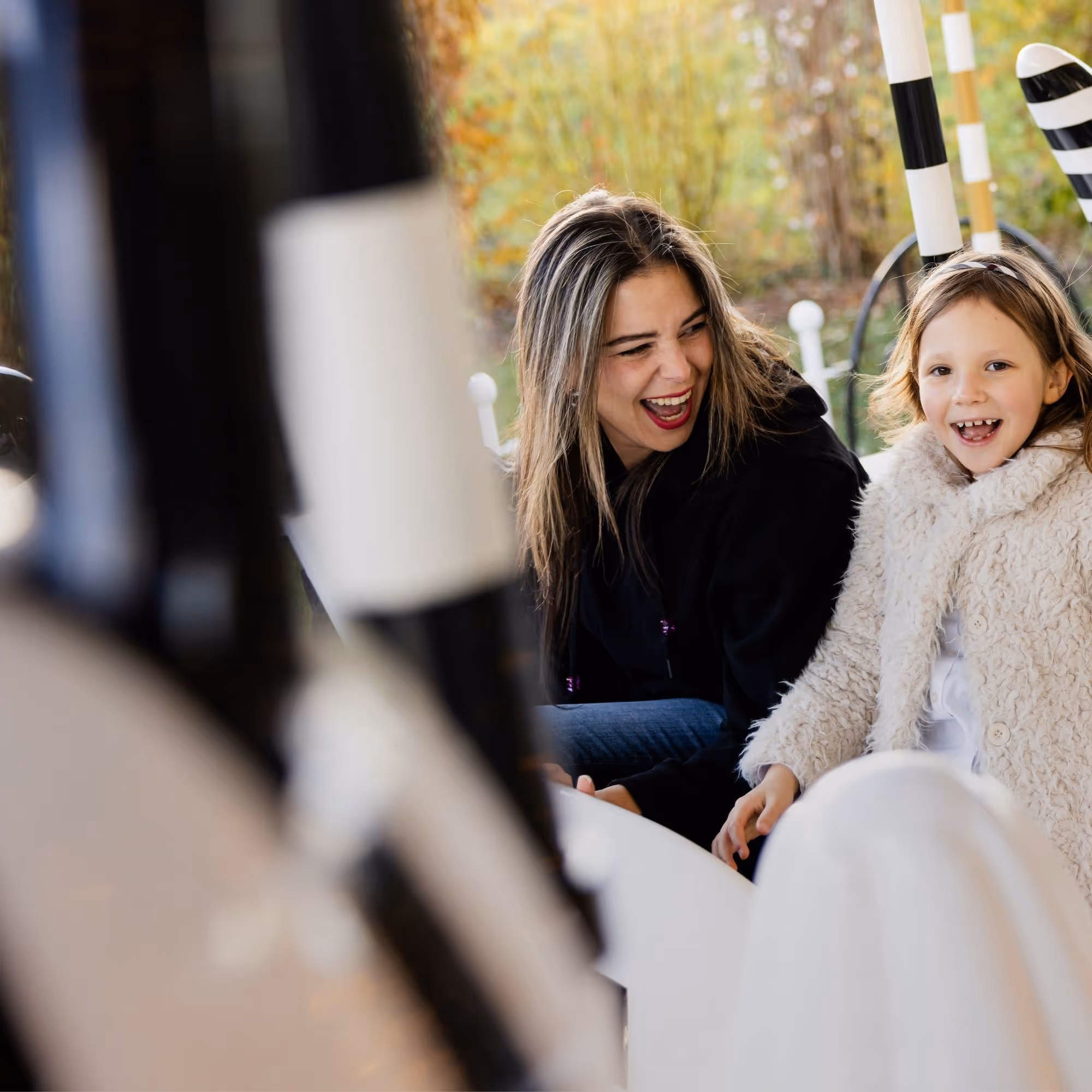 Mother and daughter enjoy a ride on the carousel in the park of Swarovski Kristallwelten — one of many unforgettable experiences with the annual pass.