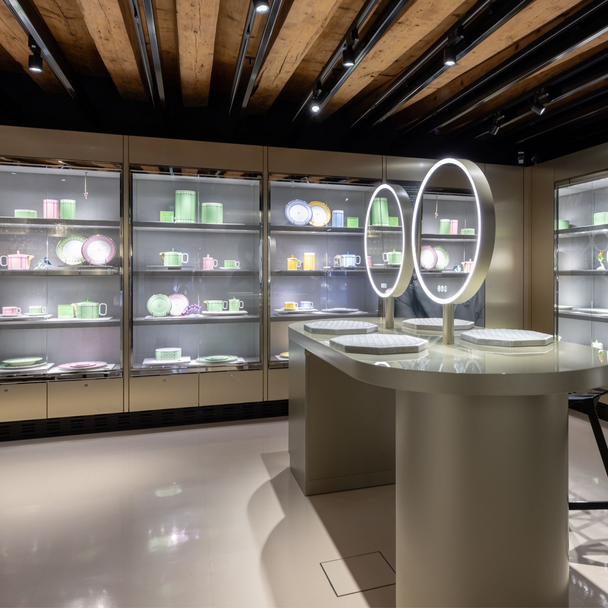 Interior view of the Swarovski Kristallwelten Store Innsbruck with colorful showcases and modern jewelry presentations in pastel color displays.
