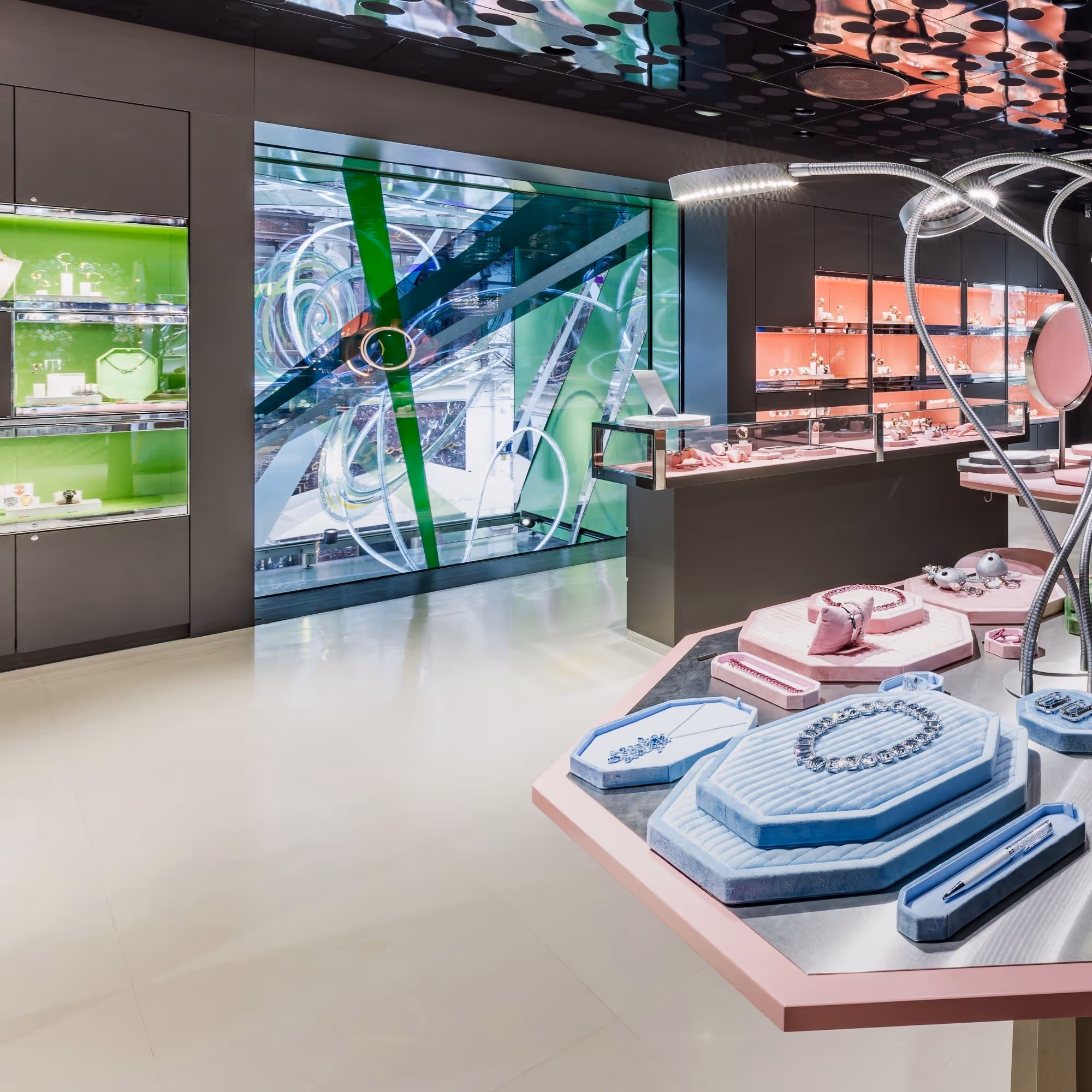 Interior view of the Swarovski Kristallwelten Store Wien with colorful showcases and modern jewelry presentations in pastel color displays.
