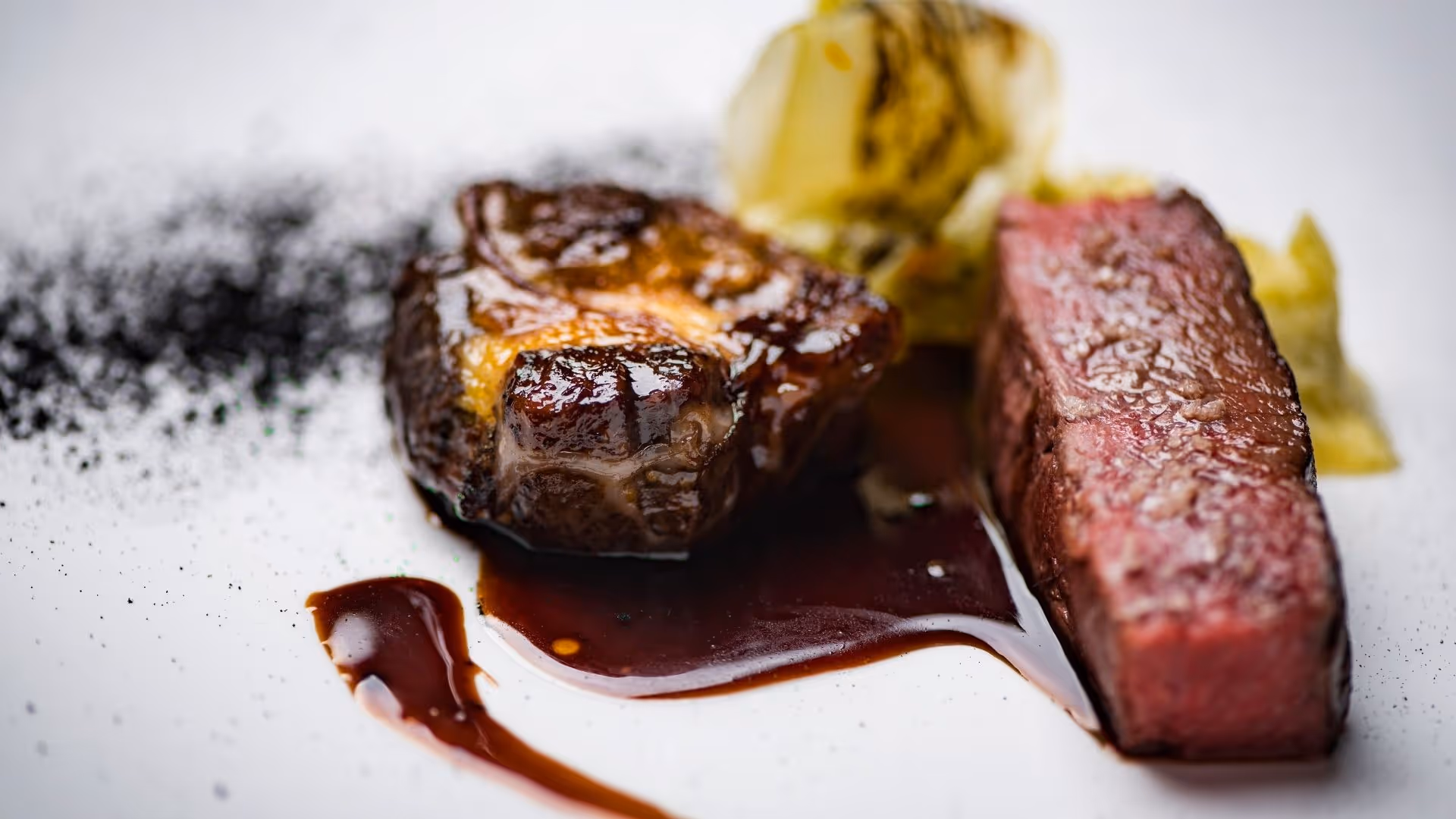 Finely prepared gourmet dish at Daniels Kristallwelten by DoN at Swarovski Kristallwelten Wattens — tender steak with sauce and vegetable garnish.