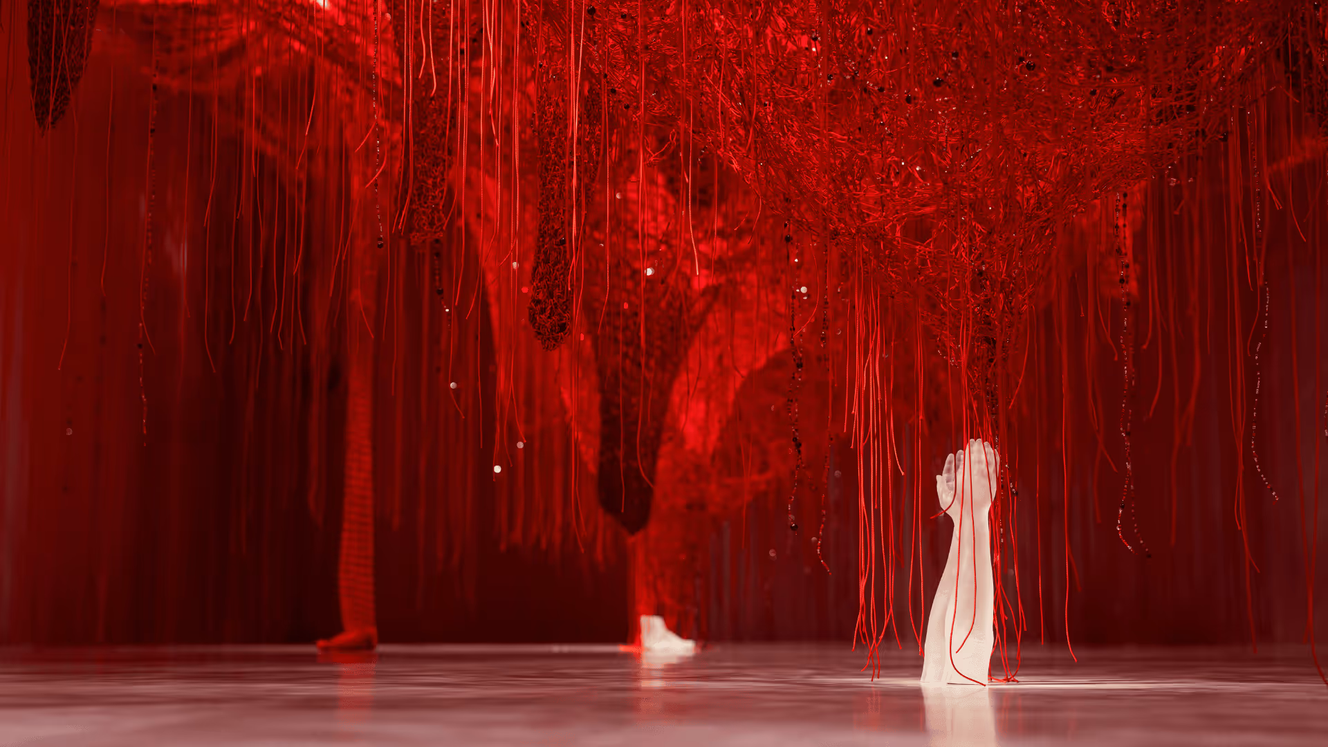 Chamber of Wonder Crystallizing Identity by Chiharu Shiota at Swarovski Kristallwelten: A dense network of red threads with incorporated crystals, from which a white crystal hand rises.