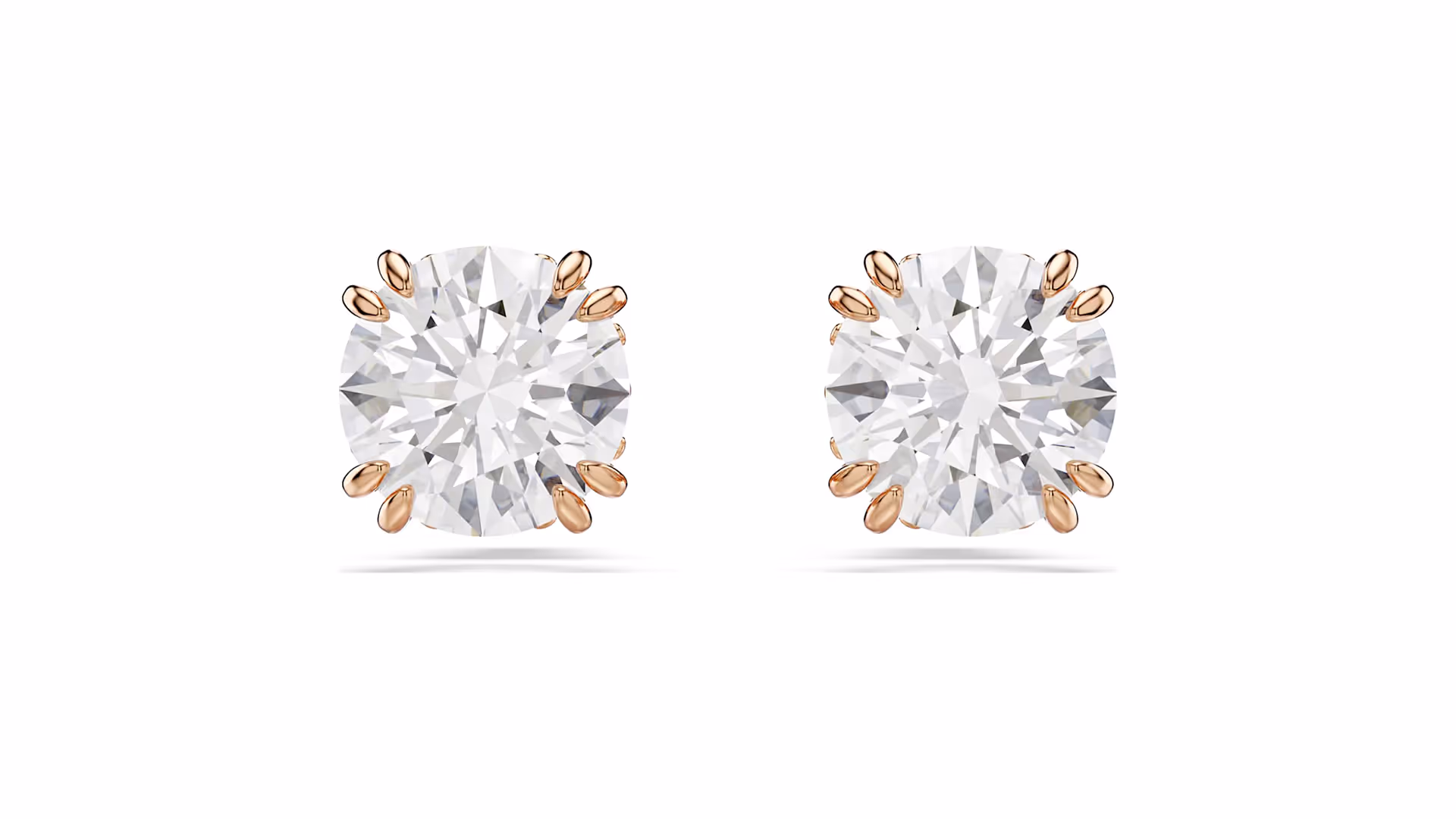 Pair of sparkling round Swarovski earrings with clear crystals, set in rose gold-colored prongs.