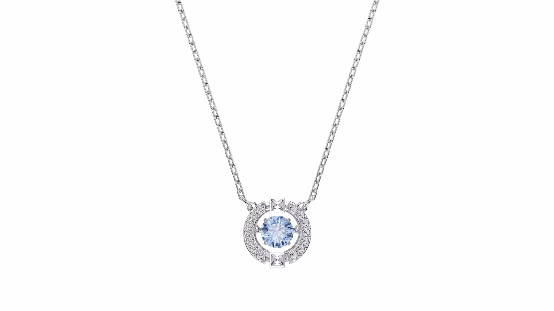 Fine, silver-colored Swarovski necklace with filigree chain. In the middle, a round pendant with bright blue crystal, surrounded by small clear crystals and geometric details. Set against a white background, focus on symmetry, polish and elegant design.