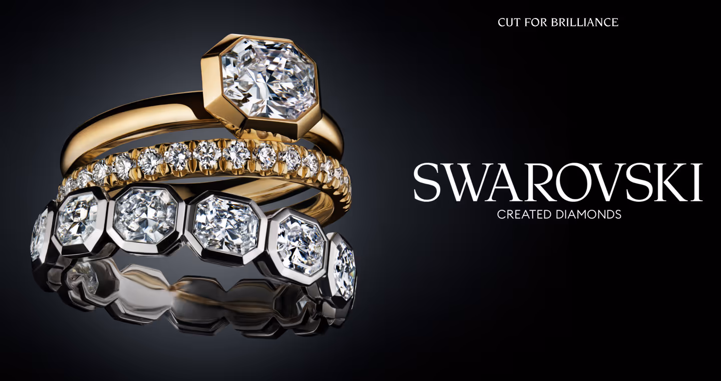 Swarovski Created Diamonds: Three sparkling rings staged on a black background.