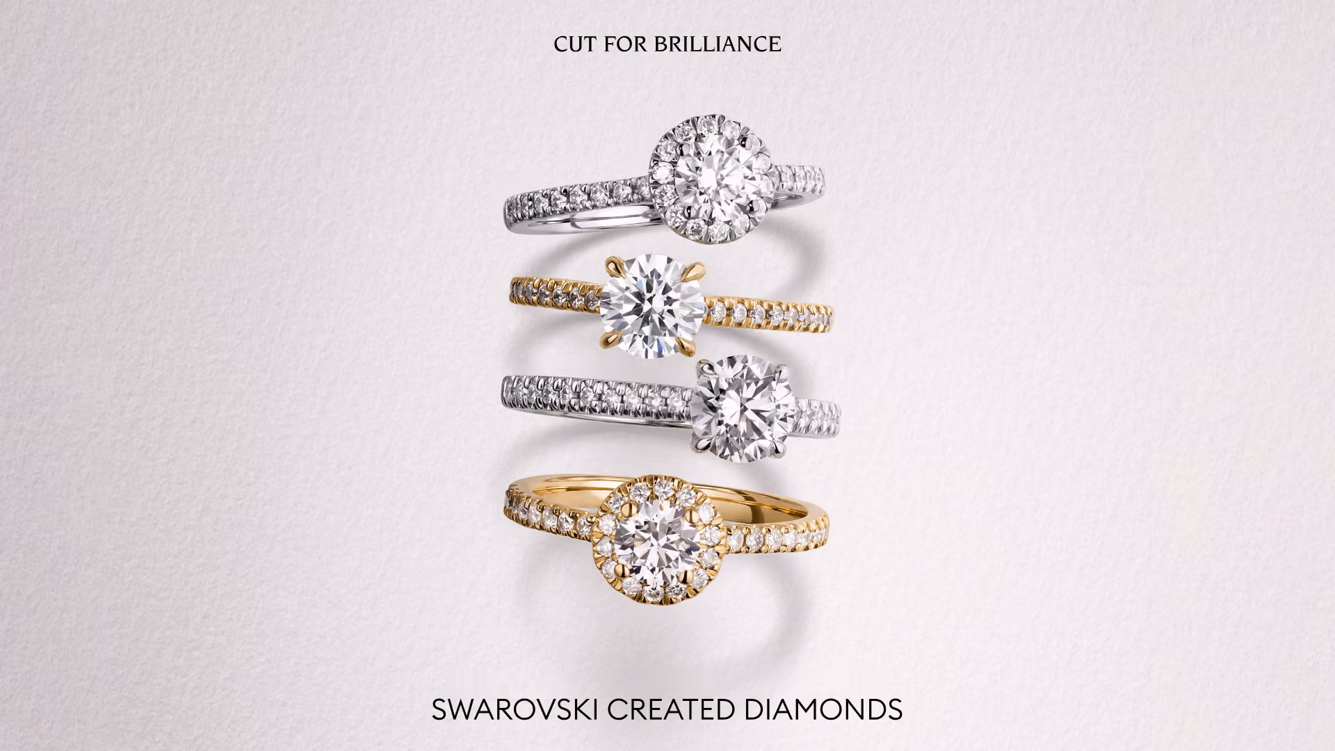 Four Swarovski Created Diamonds rings in white and yellow gold with diamonds against a light background; “Cut for Brilliance” lettering.