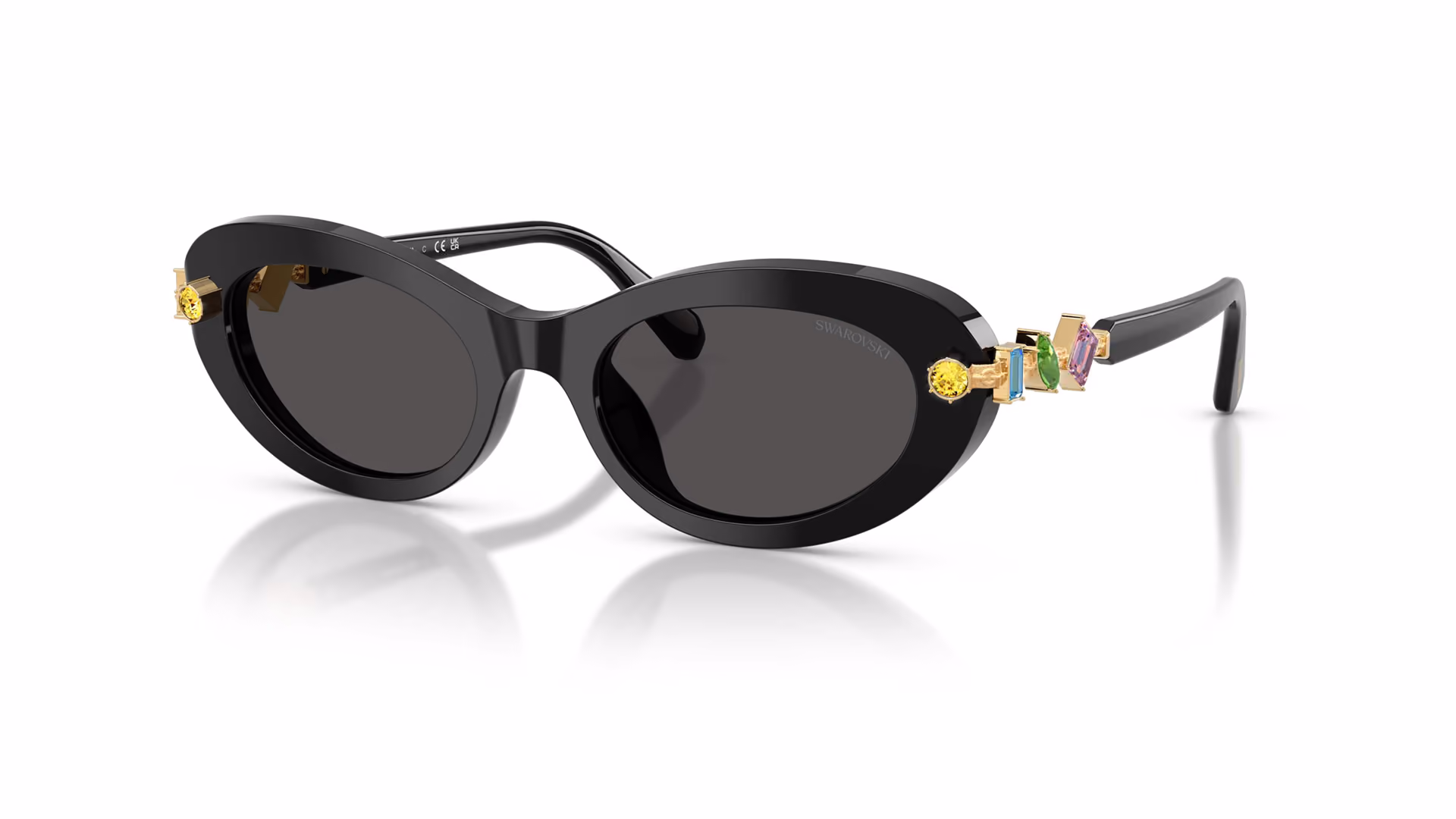 Black sunglasses studded with colorful crystals against a light background.