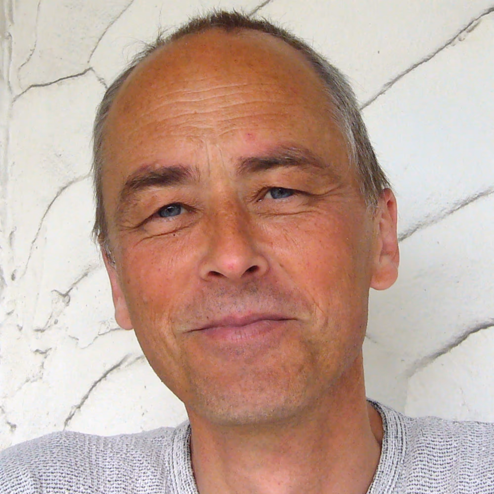 Gernot Candolini, österreichischer Künstler, 2009 im hellen Pullover, freundlich in die Kamera blickend.