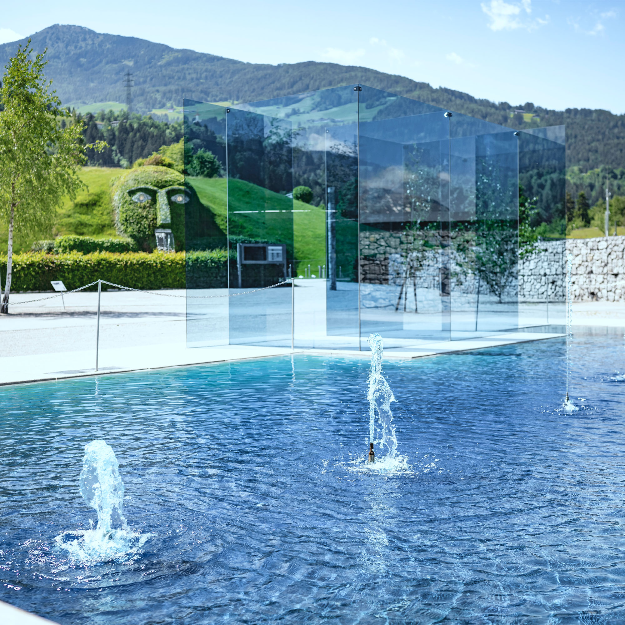 Installation 'Ford Crystal Blue': Ein blaues Glaskonstrukt in einem blauen Wasserteich vor den Swarovski Kristallwelten.