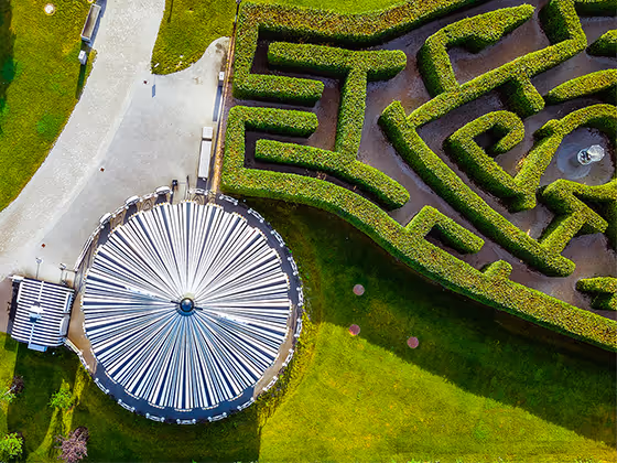 Labyrinth im Park: Geometrisch gestaltete Heckenanlage, die Besucher zum Erkunden einlädt.