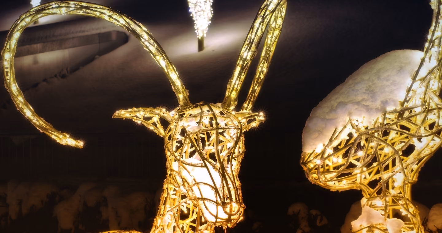Illuminated animal figure with long horns in the winter parkland of Swarovski Kristallwelten's Winter Wonderland.