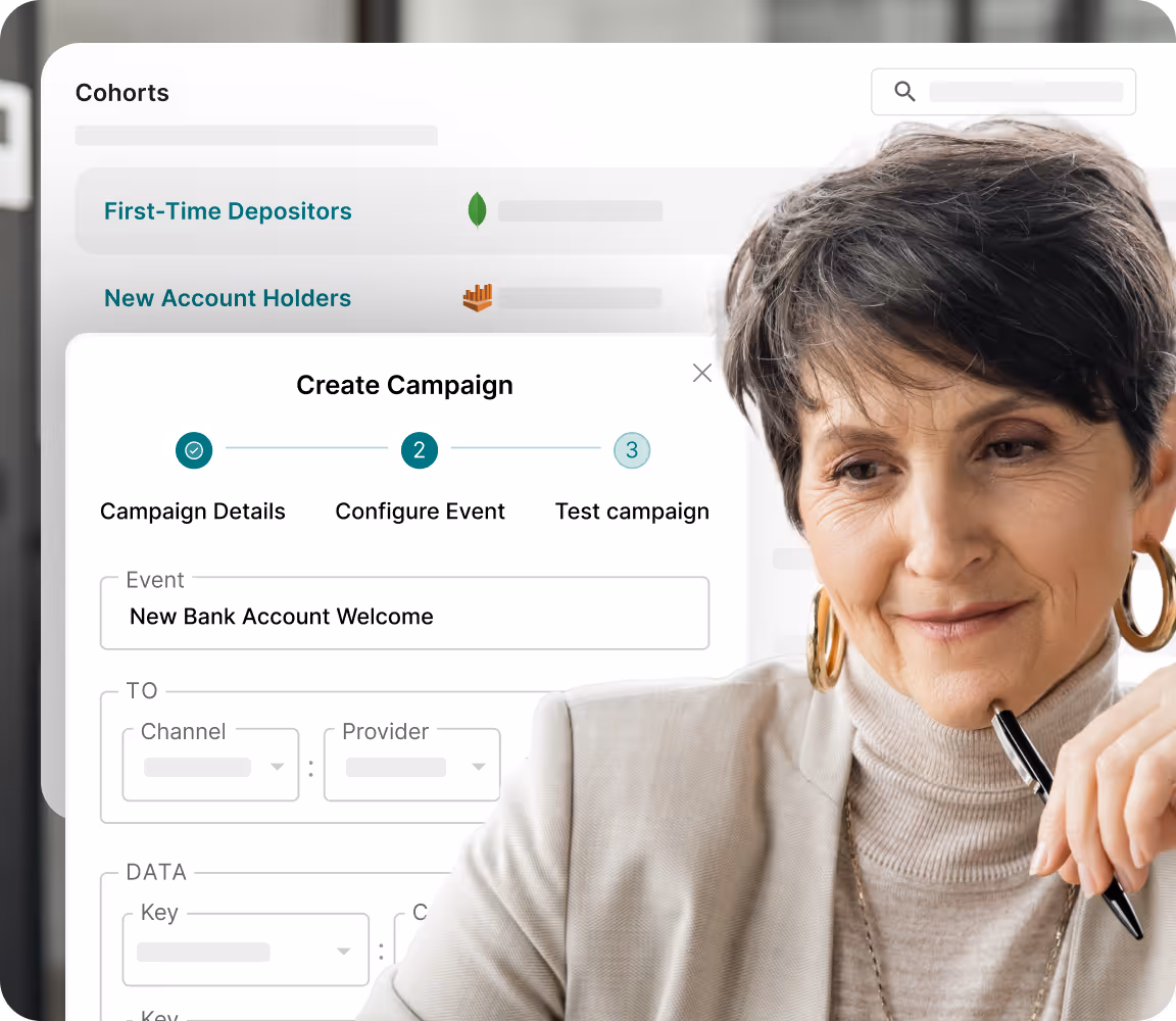 Woman holding a pen, looking thoughtfully at a computer screen displaying a 'Create Campaign' interface for configuring a 'New Bank Account Welcome' event.
