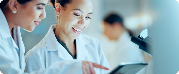 two researchers looking at a tablet